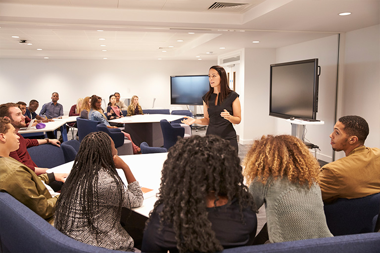 Teacher instructing in front of a classroom